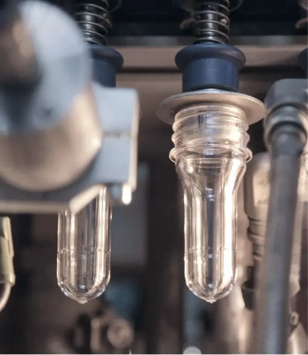 Preforms on the mandrel during insertion into the preform heater.